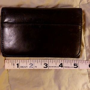 Excellent used condition HOBO black tri-fold wallet. Zipper on back for coins.